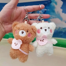 Detail of plush astronaut bear keychains in brown and white with pink crossbody bags