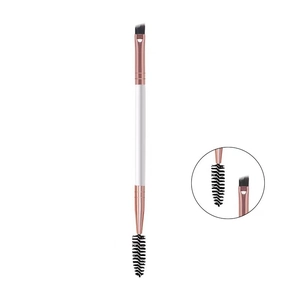 Dual-ended eyebrow brush detail showing angled bristles and spoolie with rose gold ferrule
