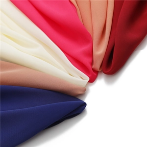 Macro detail of multicolored pearl chiffon fabric showing soft textures and vibrant tones
