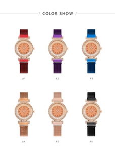 Close-up of stylish ladies' quartz watches with diamond bezels and magnetic mesh bands