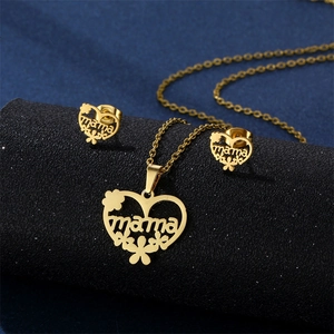 Close-up of golden stainless steel heart and MAMA engraved necklace with matching earrings