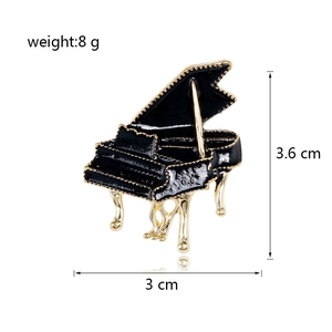 Enamel black piano brooch with gold trim and dimensions 3.6 cm x 3 cm for accessory styling