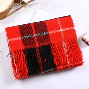 Classic red plaid cashmere-like scarf with soft fringe tassels on a minimalist background