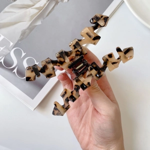 Detail of large tortoiseshell acetate hair claw clip with a strong metal spring mechanism