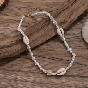 Bohemian hip hop necklace with white imitation pearls and sea shells on driftwood