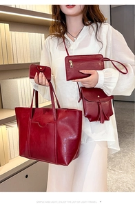 Four-piece red vintage oil wax leather bag set including tote, crossbody, clutch, and card holder