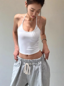 White halter top with slim fit design and soft knit fabric for summer sports look