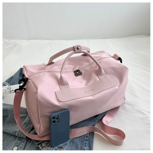 Pink large sports gym bag with NIFTY BAG logo on blue denim jacket with phone reference