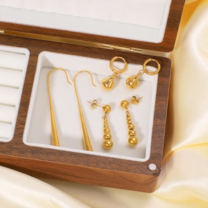 Three pairs of elegant 18K gold-plated teardrop and bead earrings in a luxury jewelry box