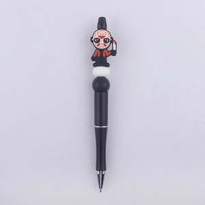 Macro detail of beadable pen with cartoon hockey mask figure and black ink refill