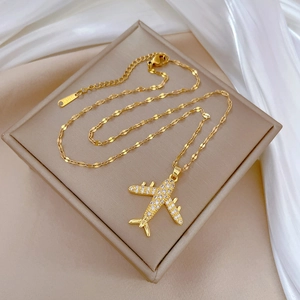Elegant gold titanium steel airplane necklace featuring sparkling zircon crystals
