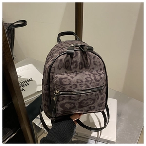 Close-up of leopard print mini backpack with suede texture and silver hardware