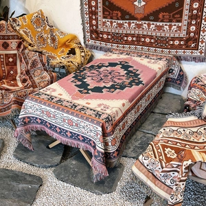 Detail of bohemian woven camping blanket with ethnic patterns and fringe texture