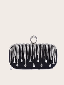 Detail of black satin evening bag featuring sparkling rhinestone fringe and a circular handle