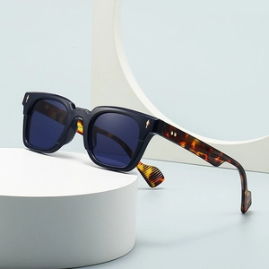 Retro cat-eye sunglasses with thick black frames and cheetah pattern temples with gold accents