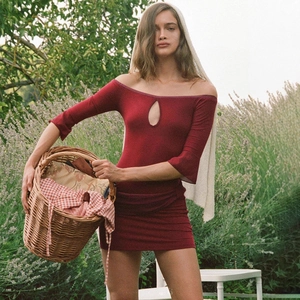Close-up of deep red bodycon dress with teardrop cutout and off-the-shoulder long sleeves