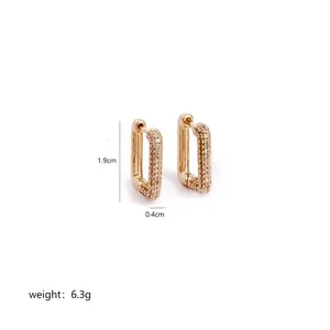 Detailed view of gold rectangle hoop earrings with pavé set cubic zirconia stones
