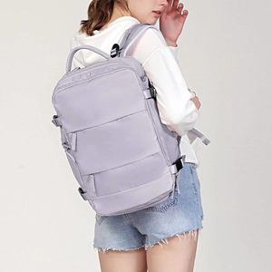 Close-up of light purple travel backpack featuring multiple functional zipper compartments