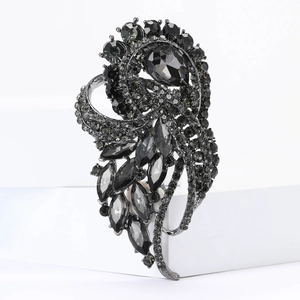 Detailed macro shot of vintage gun-metal alloy brooch with teardrop crystals and rhinestones