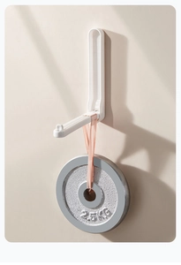 Detail of white folding wall hook holding a 2.5kg weight to show strong load capacity
