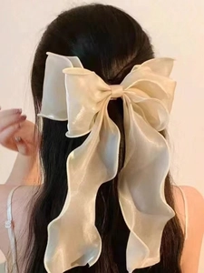 Elegant champagne organza bow hair clip with long ribbons for feminine hairstyling