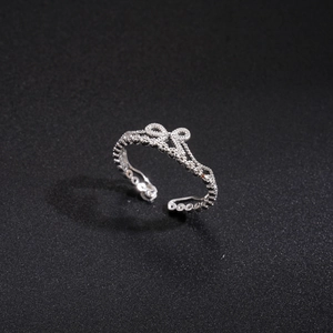 Detail of silver crown ring with cubic zirconia and adjustable open band design