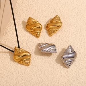 Detail shot of conch pendant wax cord necklace and metallic stud earrings set