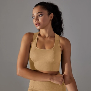 Detail of mustard yellow seamless sports bra with honeycomb breathable texture and racerback