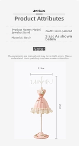 Detail view of pink resin mannequin jewelry stand with dimensions and hand-painted dress