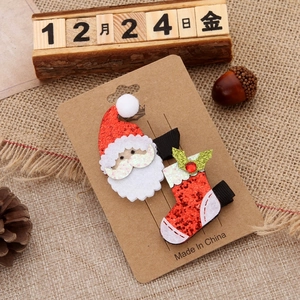 Christmas hair clips set featuring Santa Claus and sequin stocking on card