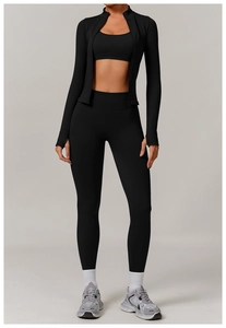 Close-up of black seamless three-piece yoga set including jacket, bra and high waist leggings