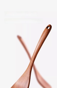 Close-up of curved ebony wood spatula with natural grain and convenient hanging hole