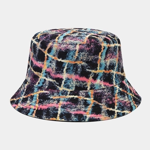 Detail shot of a double-sided bucket hat with artistic graffiti plaid patterns in bright colors