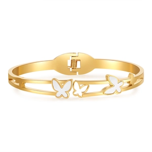 Golden stainless steel cuff bracelet featuring white butterfly charms in a minimalist style