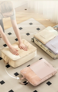 Travel compression bag detail showing double zipper design for 50% space saving