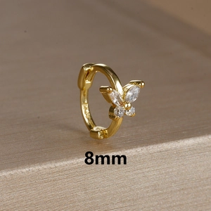 Macro shot of 8mm gold butterfly huggie hoop earring with S925 hallmark detail