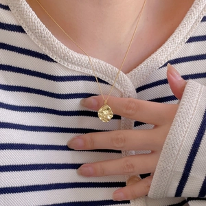 Elegant gold 925 silver irregular hammered circle necklace worn on model for chic style