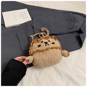 Detail of handmade crochet lion bag featuring knit texture and cute cartoon animal design