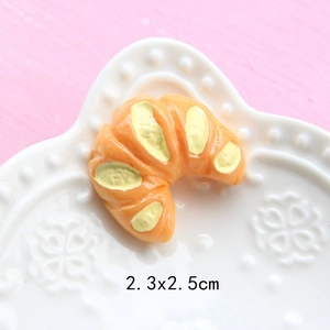 Detailed macro view of a 2.3x2.5cm resin croissant miniature for DIY dollhouse crafts