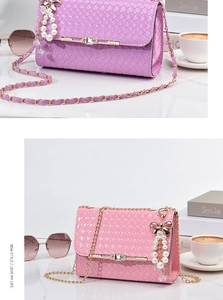 Detail of woven chain bag with gold bow, pearl tassel and crystal buckle in purple and pink