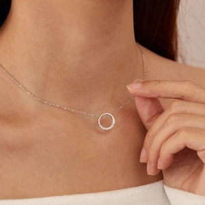 Close-up of geometric circular necklace with zircon stones on stainless steel O-chain