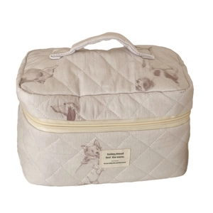 Beige quilted makeup bag with dog print and top handle for organized storage