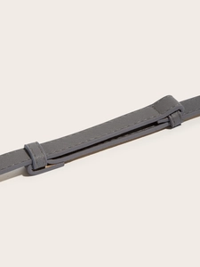 Macro shot of grey cross-pattern leather texture and durable stitching on a slim waist belt