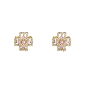 Macro shot of gold clover stud earrings featuring pink gemstone and cubic zirconia pavé