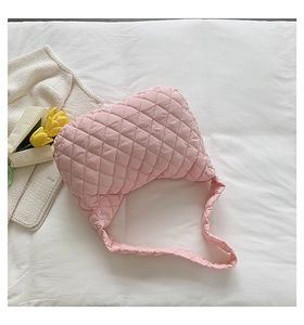Close-up of pink quilted cloud tote bag with rhombus texture and soft fabric
