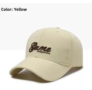 Detailed close-up of brown 3D letter embroidery on a beige cotton baseball cap