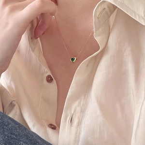 Elegant 925 sterling silver heart necklace with green gemstone on a gold choker chain