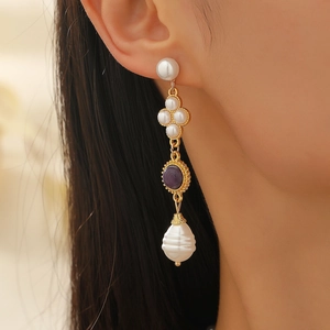 Vintage jewelry set featuring baroque pearl tassel earrings with purple stones and gold accents