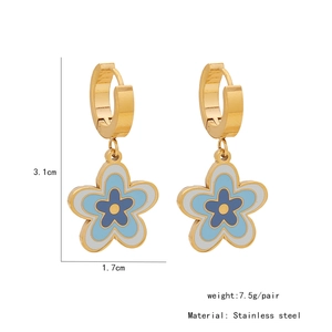 Macro view of blue and white enamel flower earrings in stainless steel with size specs