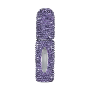 Macro detail of purple rhinestone perfume bottle with clear liquid level window